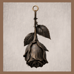 Gothic wilted rose ornament with dark petals and thorned stem on neutral background